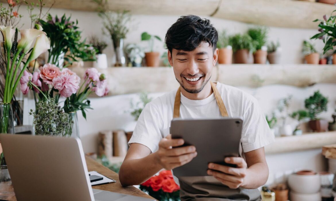 Business professional using a tablet and laptop while working online