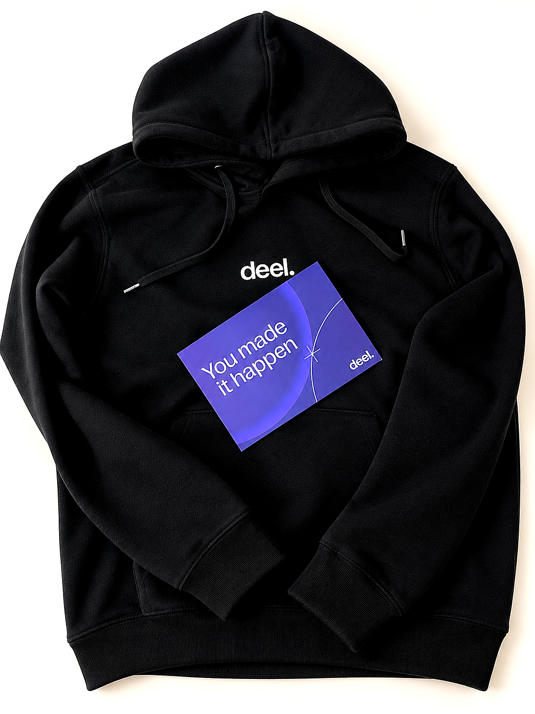 Deel: Streamlining Global Payroll & Contractor Payments 6 Person wearing a black Deel hoodie and holding a purple Deel appreciation card.
